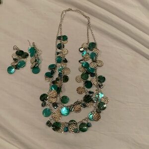 GUC necklace and earrings set in silver and teal tones.
